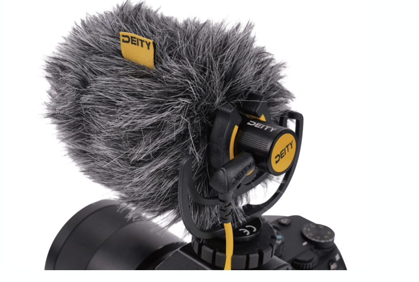 Deity V-Mic D4 Mini shotgun microphone with faux fur windshield mounted on a camera